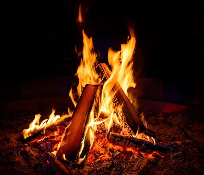 a small campfire burning bright in the dark night